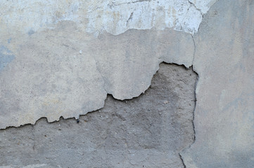Old cracked wall of an abandoned house close-up. Abstract background