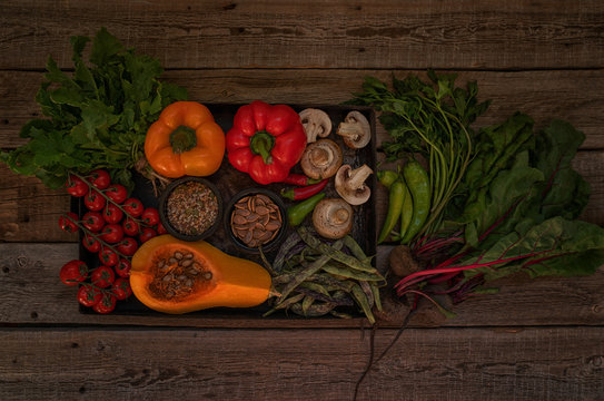 Vegetables on vintage wooden background. Autumn harvest. Organic food background. Farmers vegetable market. Seasonal fall vegetables. Rural still life from above with free text space. Toned image.