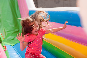 A cheerful child plays in an inflatable castle