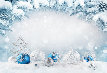 Merry Christmas background. Blue christmas balls and baubles and wooden decorative tree on the snow...