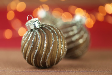 Christmas and New Year winter festive background.Brown shiny christmas balls  set on red background with yellow bokeh.Phone christmas wallpaper.Winter holidays.