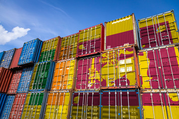 The national flag of Sri Lanka.on a large number of metal containers for storing goods stacked in...