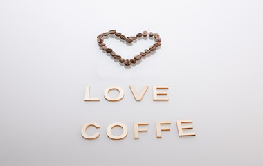 Coffee seeds heart and word love coffe under