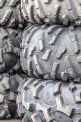 A stack of offroad tires prepared for motorsport competitions.