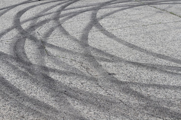 Black tracks on the pavement from a drift car.