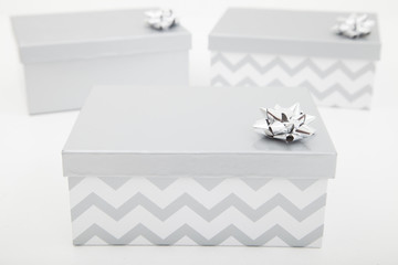 three silver gift boxes on white background 