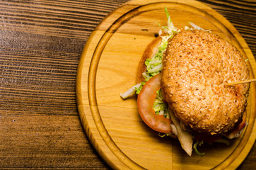 Bacon burger with beef patty on wooden table