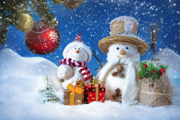 Snowman in a snowdrift with gifts for Christmas and New year