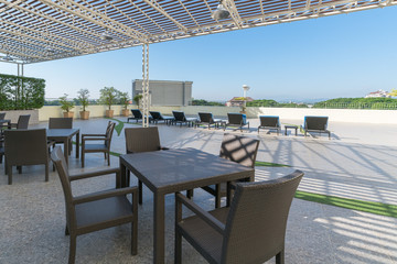 Modern terrace with chairs and tables in a sunny day