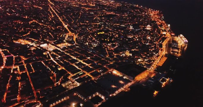 Aerial view of illuminated downtown of Lisbon overlooking Commerce Square with Rua Augusta Arch at night, Portugal