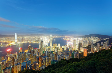 Fototapeta na wymiar Night scenery of Hong Kong viewed from top of Victoria Peak with city skyline of crowded skyscrapers by Victoria Harbour & Kowloon area across the busy seaport ~ Cityscape of Hongkong in blue twilight