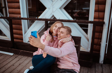 A young couple in love takes a selfie on the phone. Husband and wife embrace. lovers on vacation take a selfie