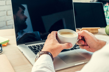 Close up of a working table of a businessman with laptop