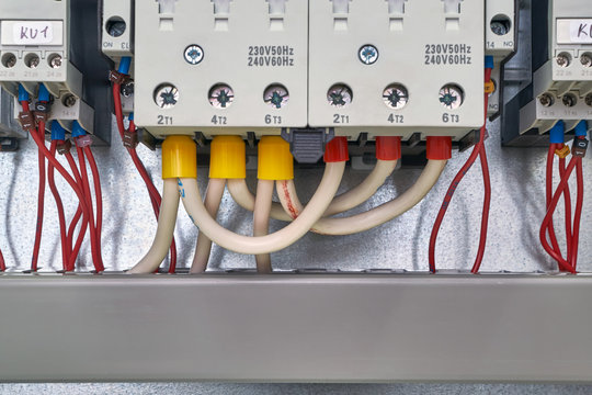 Electrical cables and wires are connected from the bottom of contactors or starters and phase control relays. At the bottom there is a cable channel in which the wires are laid. Modern technology.
