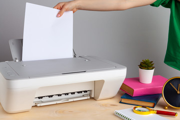 Close up of woman using a printer machine