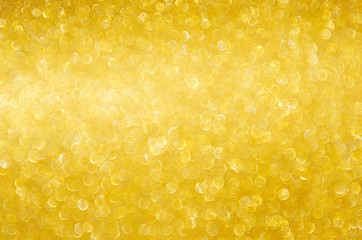 Golden shining glowing bokeh abstract texture for Christmas and festive design.