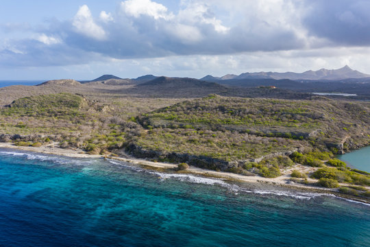 Aerial view of coast of Curaçao in the Caribbean Sea with turquoise water, cliff, beach and beautiful coral reef around Sta. Martha Bay