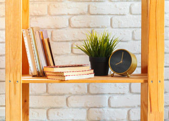 Wooden shelf with home decor on ot