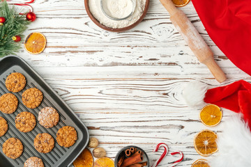 Top view of oat cookies in baking tray on wooden table