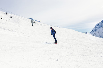 Fototapeta na wymiar Woman snowboarder on a slope winter.