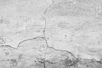 Texture of a concrete wall with cracks and scratches which can be used as a background