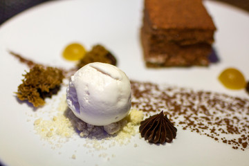 Vanilla Ice Cream with Chocolate Brownie on a beautiful plate. Ice cream. sweet and dessert. Delicious Vanilla ice cream with a slice of chocolate cake on decorated plate.