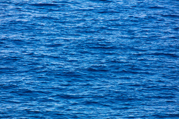 Blue expanse of water at sea as abstract background