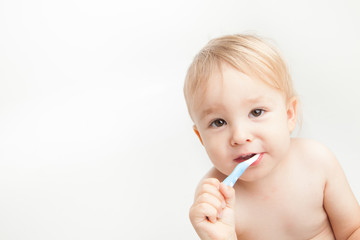 young child brushing his teeth 