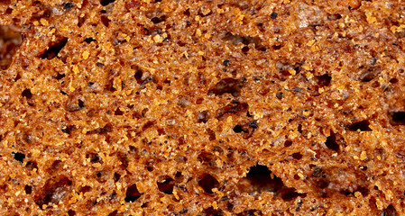 Black rye bread as an abstract background