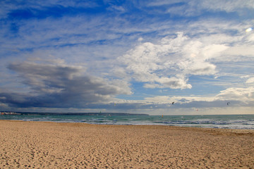 Fototapeta na wymiar Deserted beach of the island of Palma de Mallorca in windy weather.