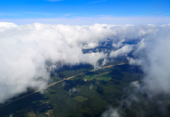 Obraz premium Clouds above the ground view from an airplane as a background