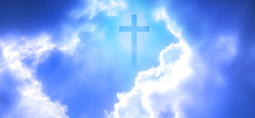 Christian cross appeared bright in the sky with soft fluffy clouds, white, beautiful colors. With...