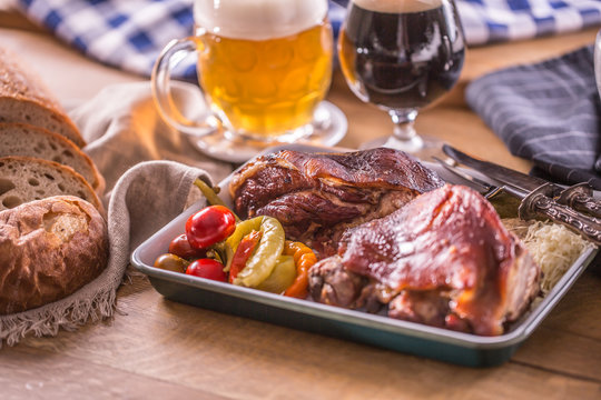 Bavarian knee traditional german czech slovak and austrian delicious food. Smoked roasted pork meat with draft beer