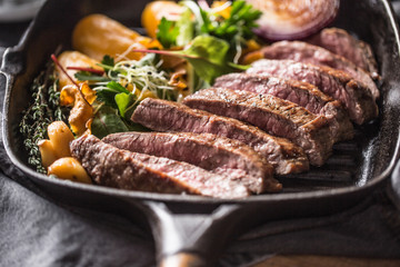 Beef flank steak in grill pan with batata puree garlic and herb decoration