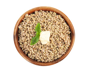 Tasty buckwheat porridge with butter isolated on white, top view