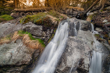 Fototapeta na wymiar Rapid stream on stones in mountain.