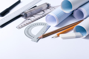 T-square, rulers, protractor, pencils, graph paper, documents on the draftsman workplace. Concept...