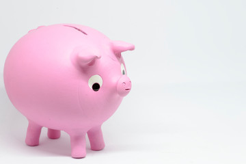 man saving money in ceramic piggy bank or mud with pink piggy shape