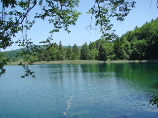 Amazing natural picture of the mirror surface of mountain lakes surrounded by wild, pristine forest.