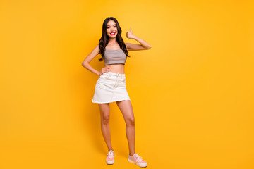 Fototapeta na wymiar Full length body size photo of cheerful positive pretty nice cute girlfriend showing you thumb up smile toothy with hand on waist isolated bright color background