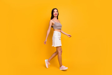 Side profile full length body size photo of cheerful positive cute pretty nice girlfriend walking forward in footwear for sales isolated vivid color background