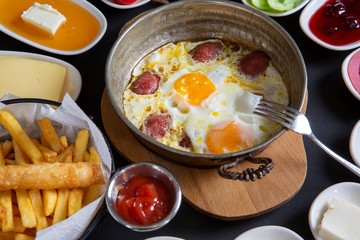 sausage with egg in copper pan turkish meal