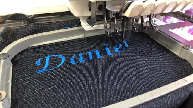 Embroidery name Daniel on fabric using an embroidery machine.