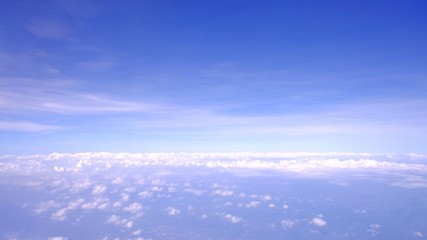 Blue sky white fluffy clouds,a view from a plane windoow