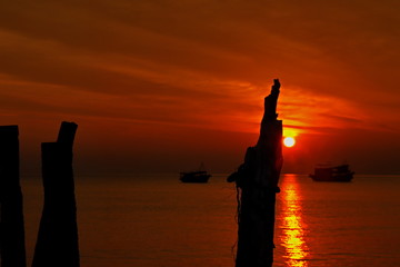 the wooden pole and Beautiful natural background of sunset and yellow red sky