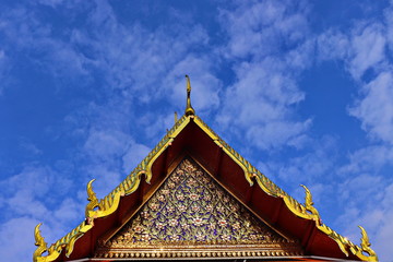 beautiful Thai temple roof contrast with blue sky