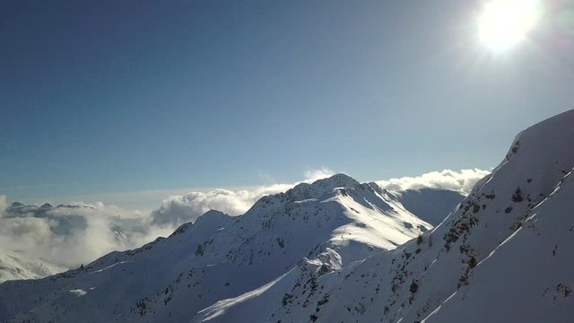 4k aerial drone footage flying side the snowy mountain ridge of Tartano Valley in Sondrio province, italian mountains in the central alps.