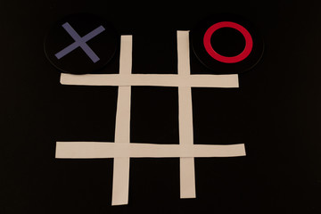 Tic Tac Toe X and O board game against the black background