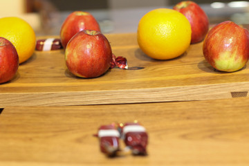 Red apple and orange on a brown wooden board. Stock photo. A concept, conceptual or metaphor wall banner, grunge, material, aged, rust or construction. Stock photo. Modern