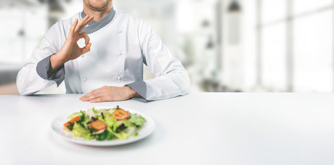 chef in restaurant showing ok sign with copy space